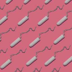 Plain tampons on a pink background. We asked an OB-GYN to debunk these toxic shock syndrome myths.