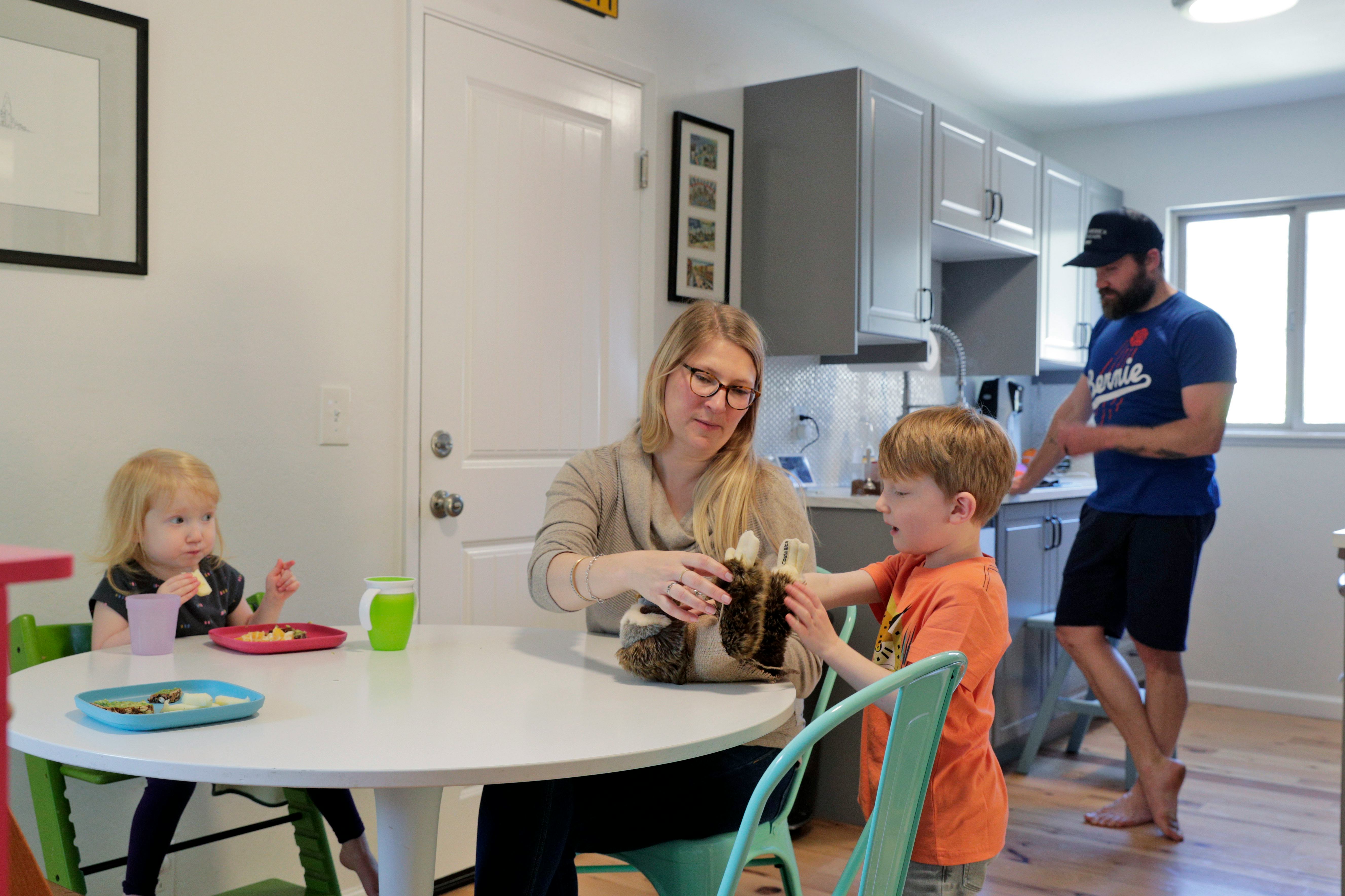 married couple with kids in kitchen during pandemic