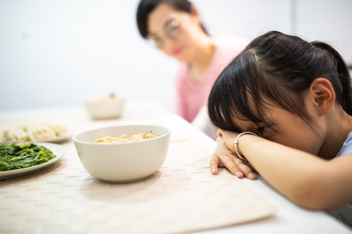 girl with head on dinner table