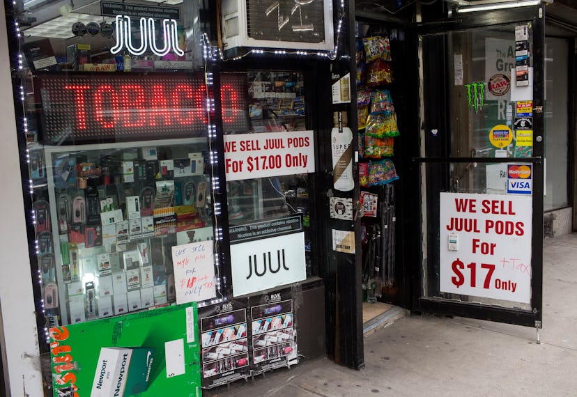 The outside of a tobacco store that sells Juuls with sings promoting that fact