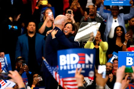 Joe Biden hugging Kamala Harris during while surrounded by a large crowd