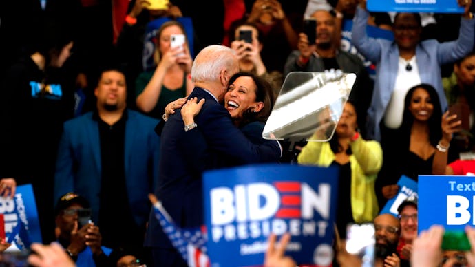 Joe Biden hugging Kamala Harris during while surrounded by a large crowd