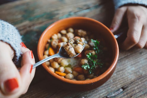 A woman eats beans in quarantine. Social distancing's effect on your gut health has to do with what ...