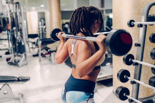 A person lifts weights in an empty gym. Gyms are reopening in Georgia, but does that mean it's safe ...