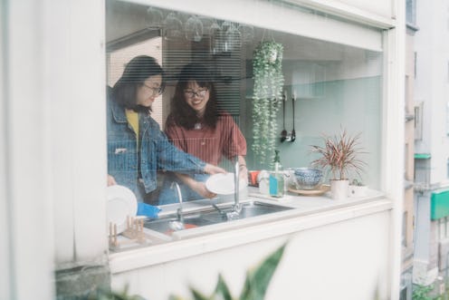 Two women cook inside their kitchen as seen from the outside of their house. What happens to your bo...