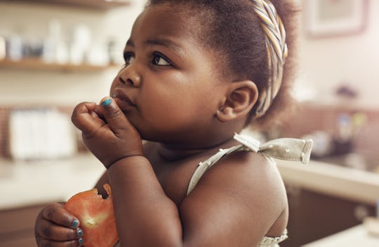 baby eating tomato 