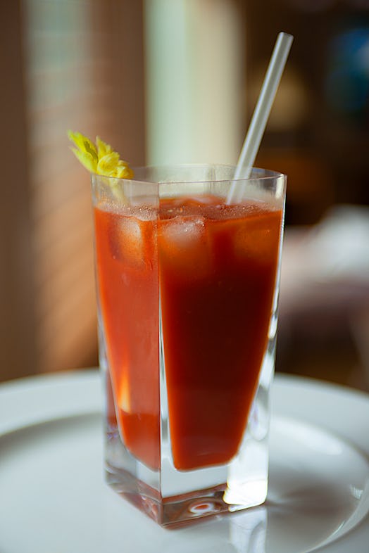 A bloody Mary had a celery stick and straw sticking out of it.