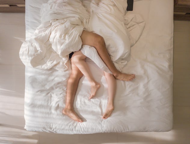 couple in bed, with their feet entangled