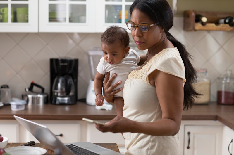 Woman working from home with a newborn during coronavirus. Isolation and stress can make burnout lik...