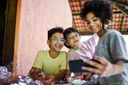 A woman takes a selfie with her two younger siblings on Easter Sunday.