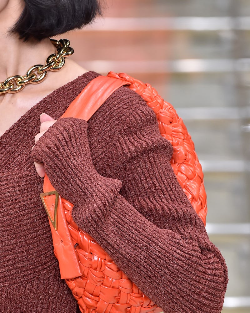 A model with a Bottega Veneta SS20 bag, as one of the 4 Summer 2020 handbag trends you can invest in...