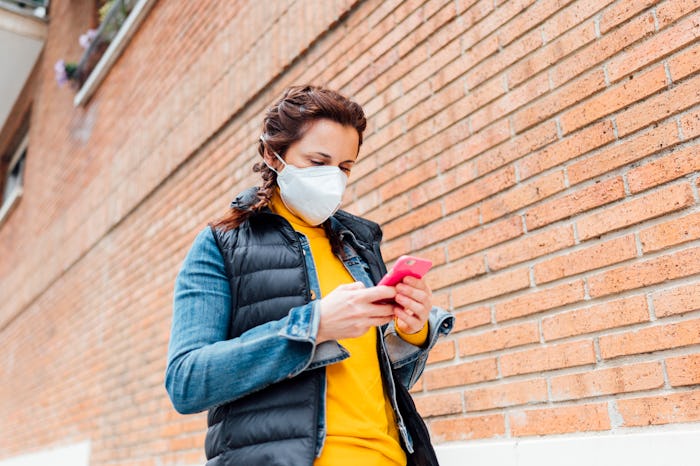 woman walking wearing face mask