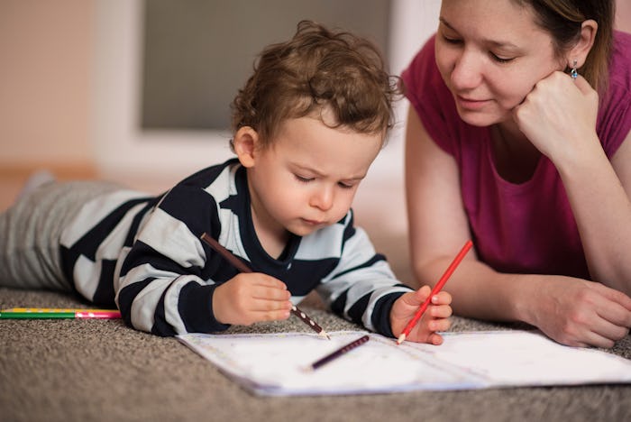 mom and little boy coloring in a coloring book