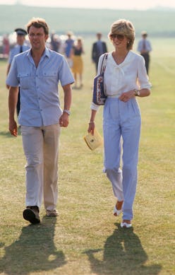 Princess Diana wearing white blouse and blue trousers.