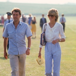 Princess Diana wearing white blouse and blue trousers.