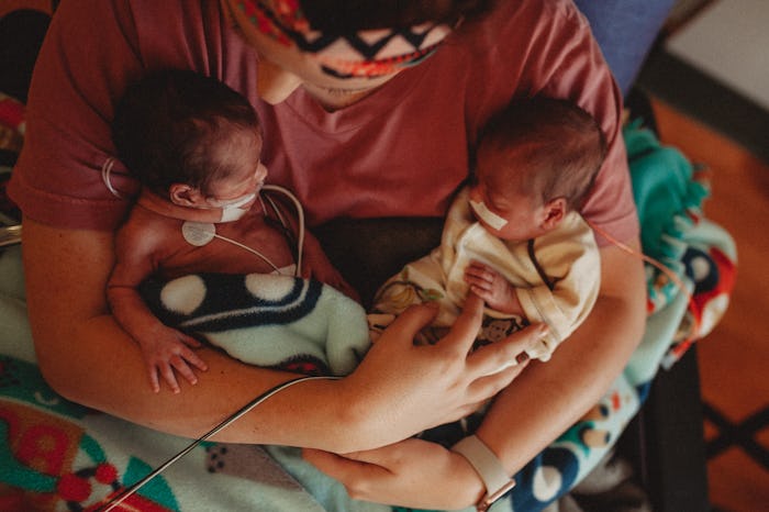 mom holding newborn twins