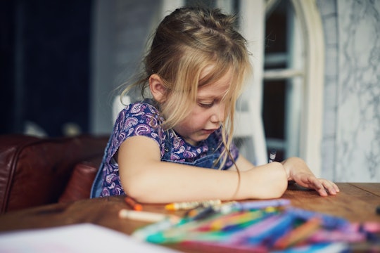 girl coloring with crayons