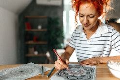 woman coloring in a printable coloring page