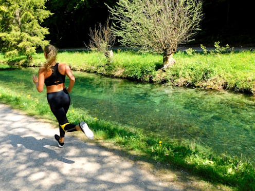 A woman jogs by a creek. Outdoor exercise can be beneficial, but doing it safely is necessary during...
