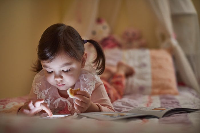 little girl playing with iphone app