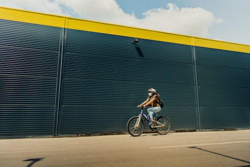 A woman rides her bike alone during the coronavirus pandemic. Riding a bike for exercise can be a go...