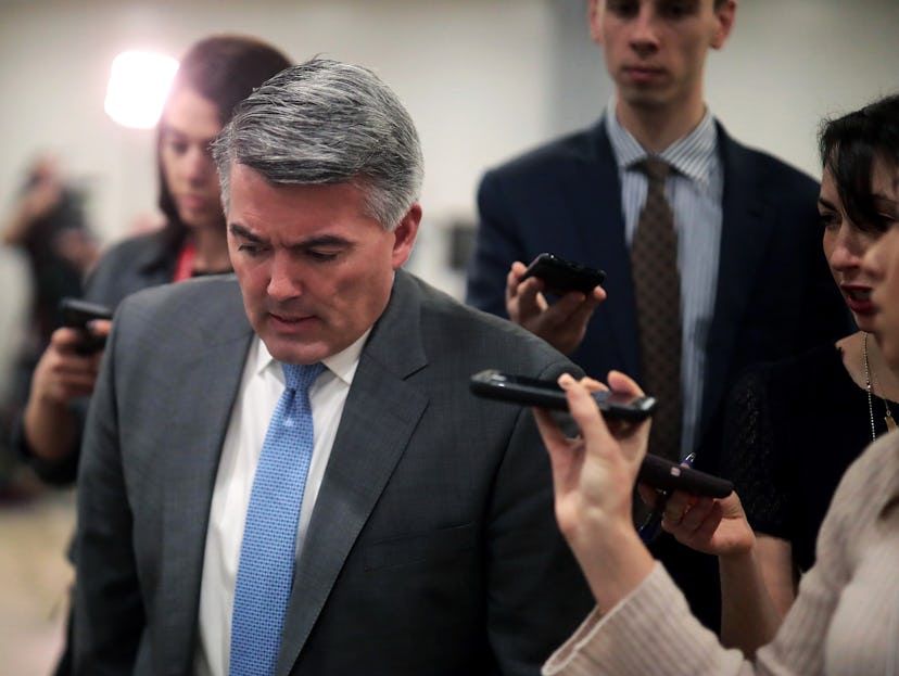 Cory Gardner walking and speaking as he is being interviewed by journalists