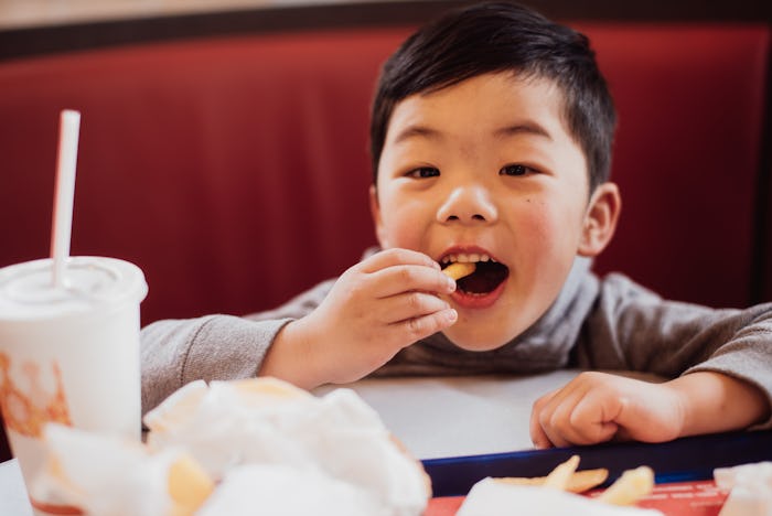 little boy eating fast food