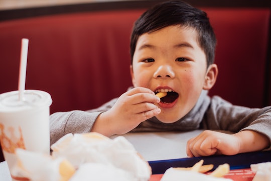 little boy eating fast food