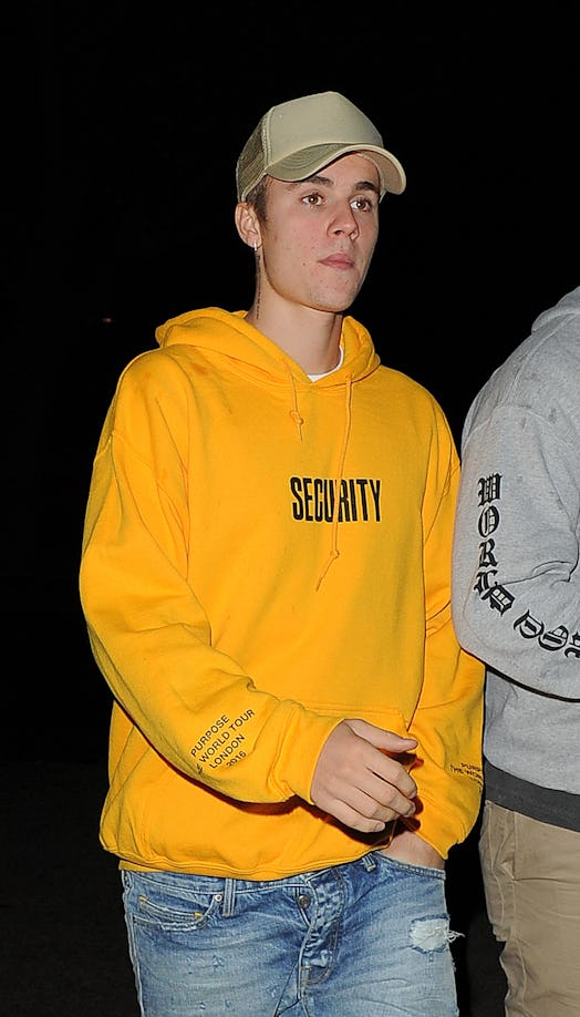 Justin Bieber steps out in a yellow hooded sweatshirt.