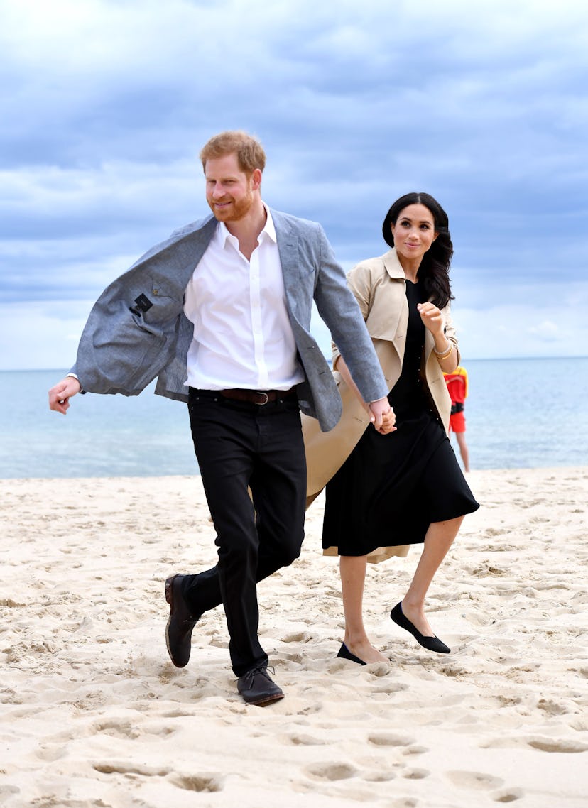 Meghan Markle and Prince Harry walk on the beach