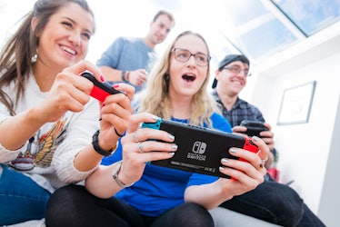 A group of friends plays on their Nintendo Switches.