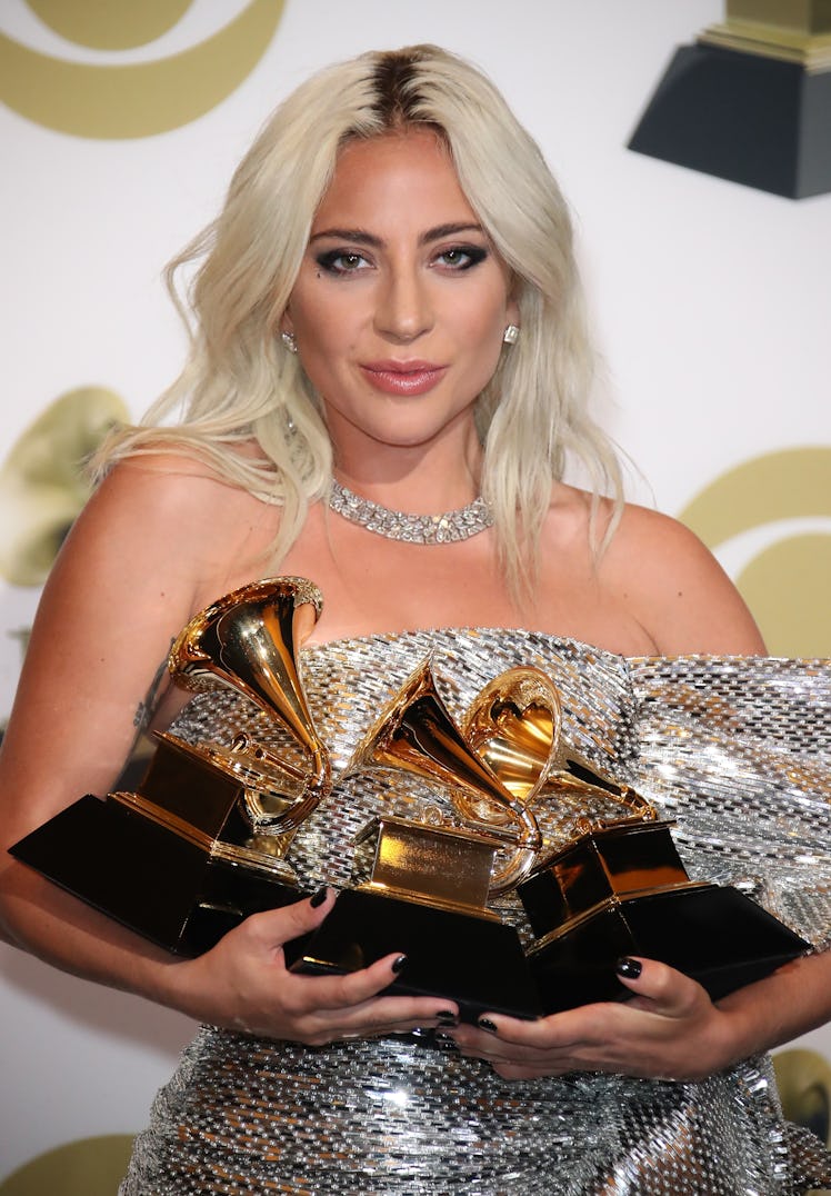 Lady Gaga poses with her Grammy Awards.