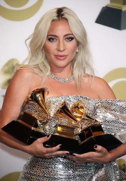 Lady Gaga poses with her Grammy Awards.