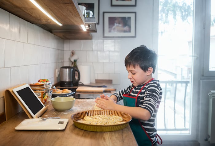 kid baking in front of tablet virtual camp