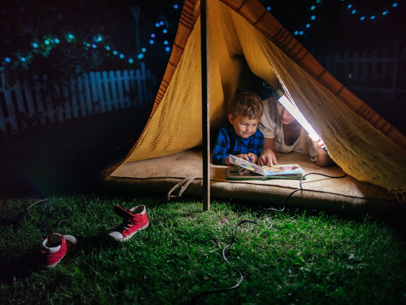 mom and boy camping in backyard tent