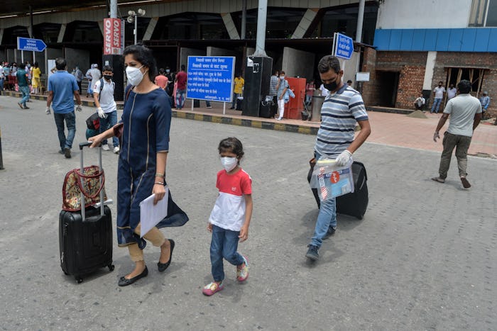family with masks at airport