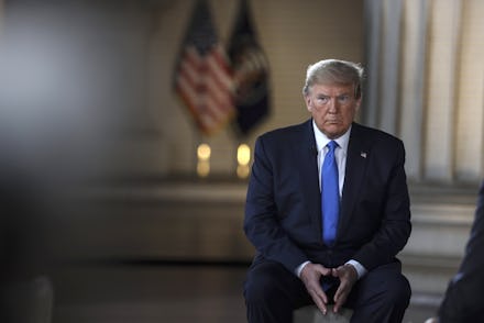 Donald Trump sitting with his hands near his lap