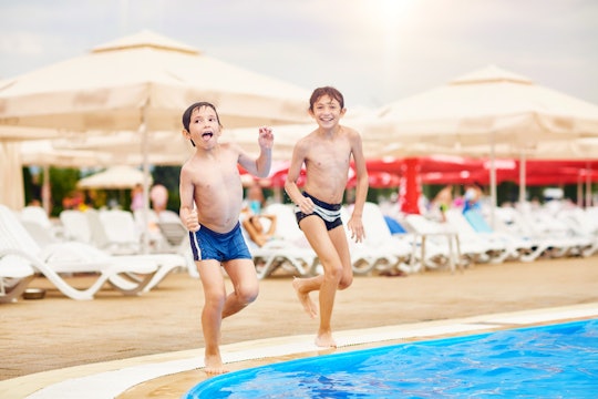 two brothers about to jump in a pool