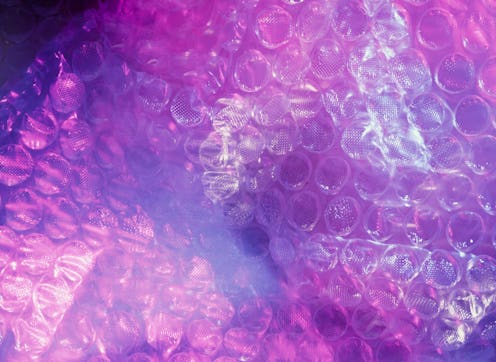 Pink bubble wrap close up. OB-GYNS explain genital pimples, warts, and other types of bumps around t...