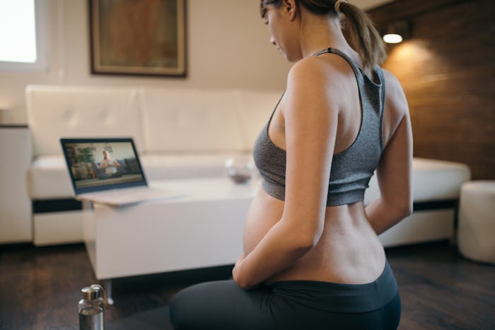 pregnant woman watching computer