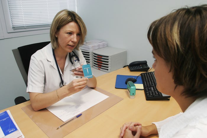 woman doctor explaining an IUD to a woman patient