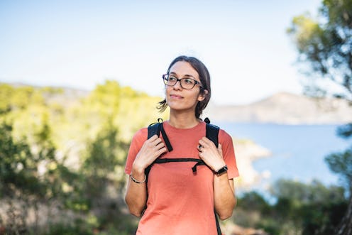 A girl with lyme disease carrying a tourist backpack during summer holidays