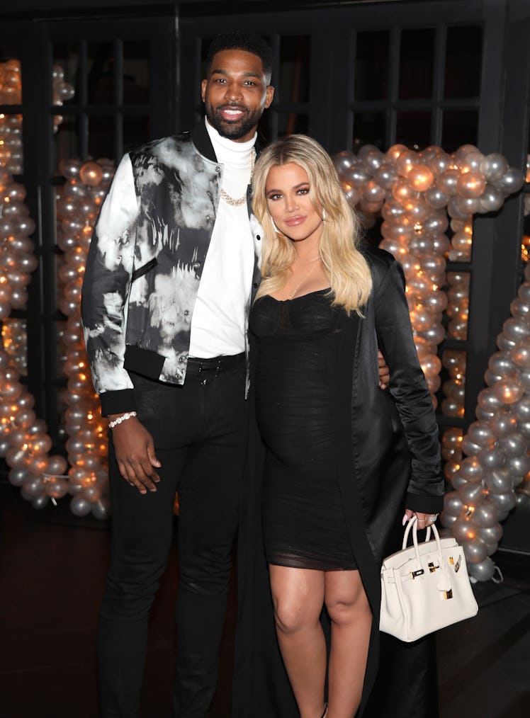 Khloe Kardashian and Tristan Thompson attend a party.