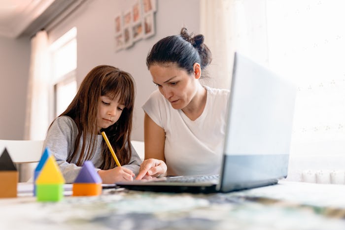 mom helping daughter with online arithmetic course