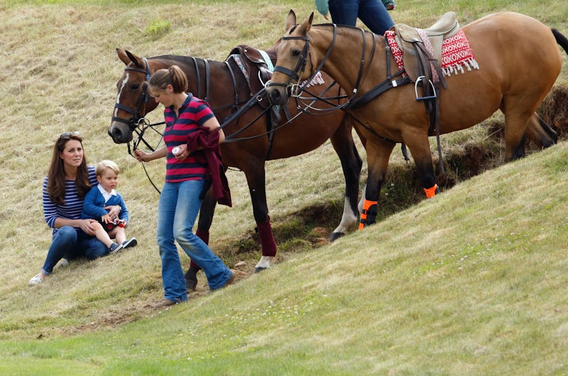 Prince George eyes some horses at his dad's polo match.