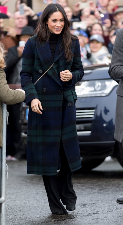 Meghan Markle dressed in a tartan plaid wool coat on a visit to Edinburgh in February 2018. 