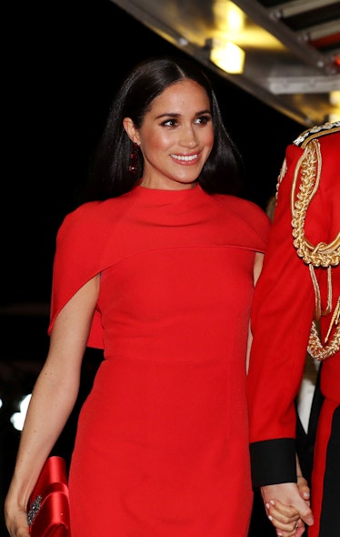 Meghan Markle steps out in a vibrant red dress.