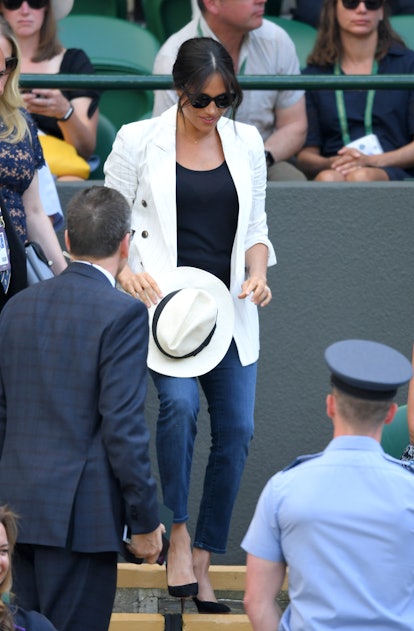 Meghan Markle wore a casual attire and a white fedora for a Wimbledon tournament in July 2019. 