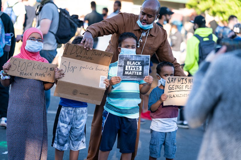 A man and his children demonstrate together