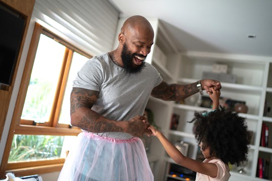 dad in tutu and daughter dancing